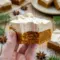 A festive tray of Frosted Gingerbread Brownies with creamy topping, styled as Gingerbread Bars With Frosting for a holiday dessert board.