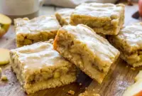 Tray of Maple Glazed Apple Blondies with a rich maple drizzle and soft apple filling, styled as Apple Blondies With Maple Glaze.