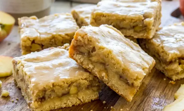 Tray of Maple Glazed Apple Blondies with a rich maple drizzle and soft apple filling, styled as Apple Blondies With Maple Glaze.
