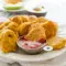 Chickpea Vegetable Nuggets on a toddler lunch plate with dipping sauce, a fun idea for Chickpea Recipes For Toddlers.