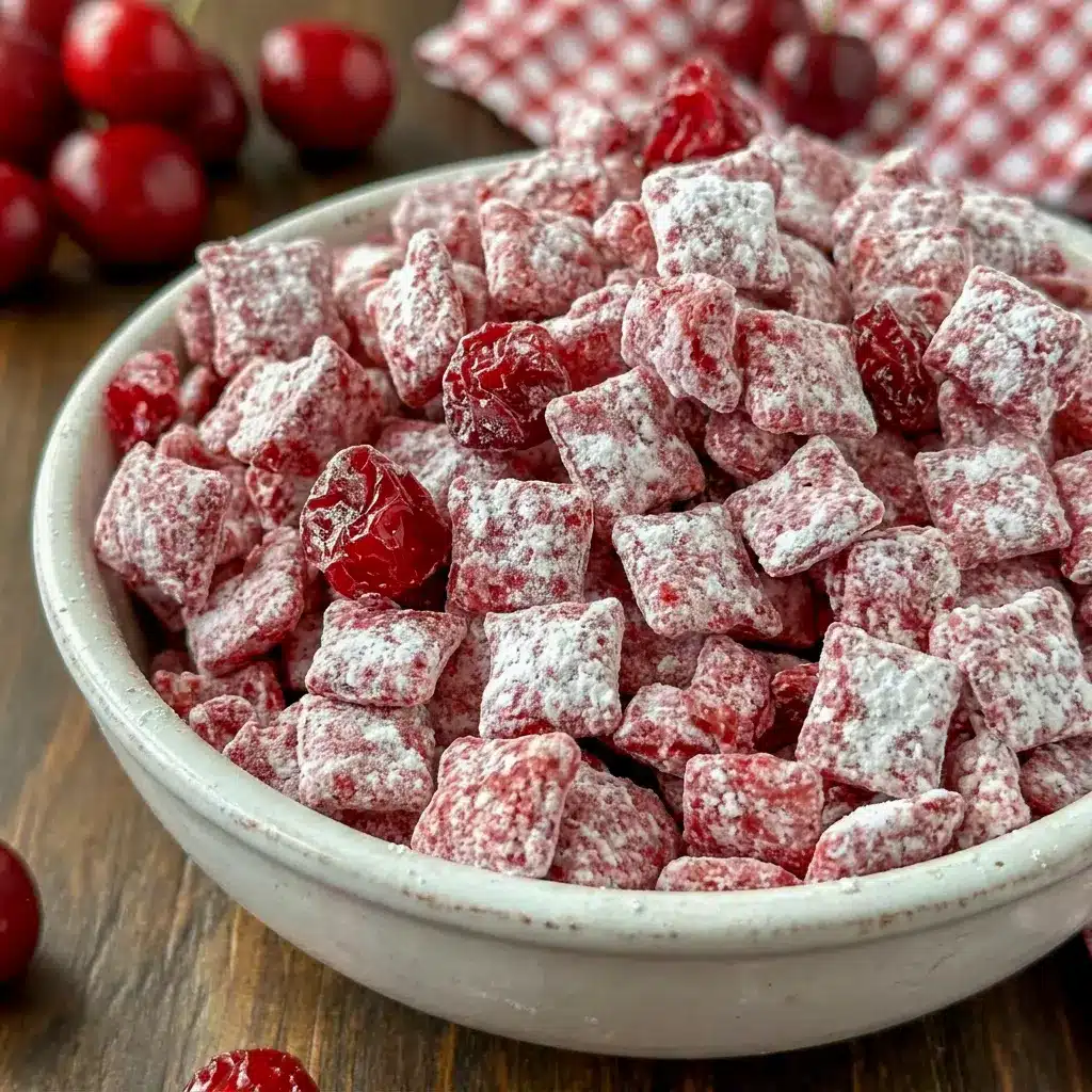 A pretty red-and-white treat made with Cherry Cheesecake Puppy Chow, ideal as a Snack For Potluck.
